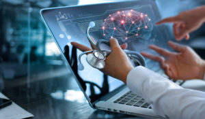 Physician looking at an image of the brain on a laptop computer