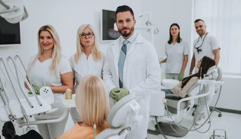Workaholism in Dentistry – dental professionals working in a busy clinic setting with patients and staff.