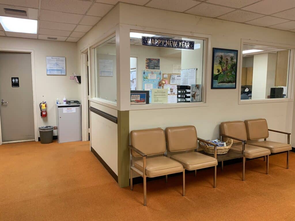 Rural hospital waiting room showing the spending bill impact on ACA premiums and how small healthcare facilities in Missouri and Kansas are affected.
