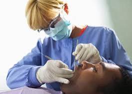 Experienced dental hygienist providing preventive care during a patient appointment, illustrating today's changing dental hygienist pay market.