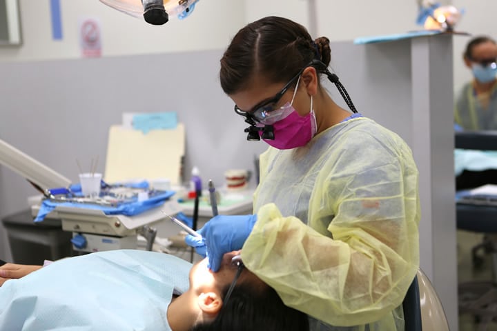 Temp RDH 1099 dental hygienist providing patient care during a temporary assignment
