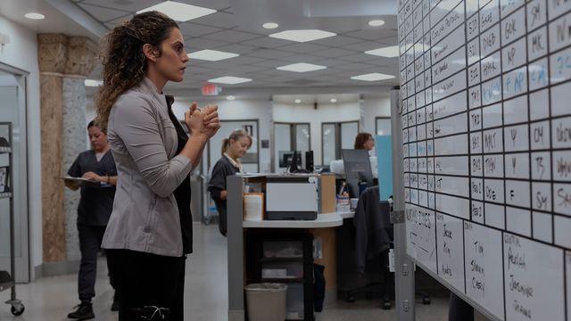 Practice manager reviewing staff schedules during healthcare staffing shortages in a busy medical office