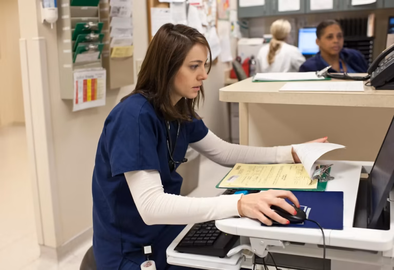 AI and healthcare jobs: clinician using technology while reviewing patient information